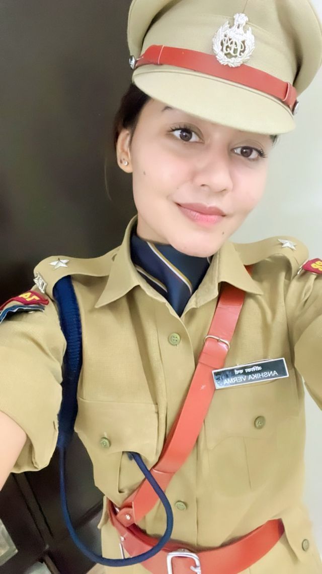 a woman in uniform is taking a selfie