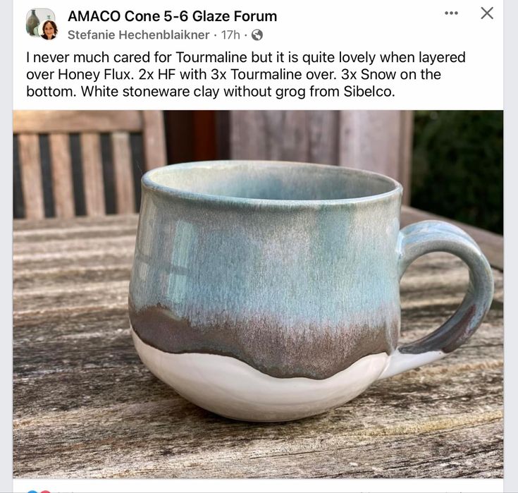 a coffee cup sitting on top of a wooden table