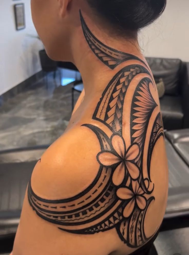 a woman with a tattoo on her shoulder