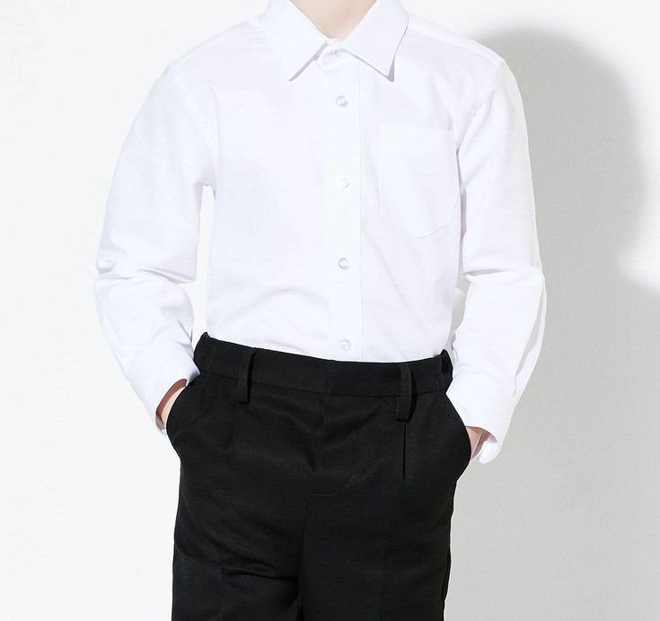 Designed with a soft polycotton blend matched with slim fit cut, this boys dress shirt features a solid look, a point collar with button closures, left chest pocket, and a shirttail hem. Slim Fit Easy Care Long Sleeves Shirttail Hem Comfortable Classic Long Sleeve Tops For School, Classic Cotton School Shirt, Classic School Tops, Classic Semi-formal Shirt With Pockets, Classic Fitted Tops For School, Classic Formal Tops With Pockets, Classic Plain Shirt With Spread Collar, Fitted Classic Plain Shirt, Classic Fitted Plain Shirt