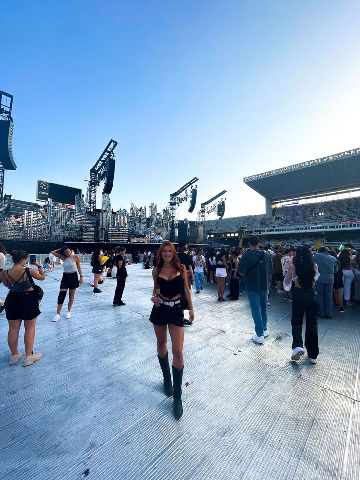 a group of people standing on top of a wooden floor in front of a stadium