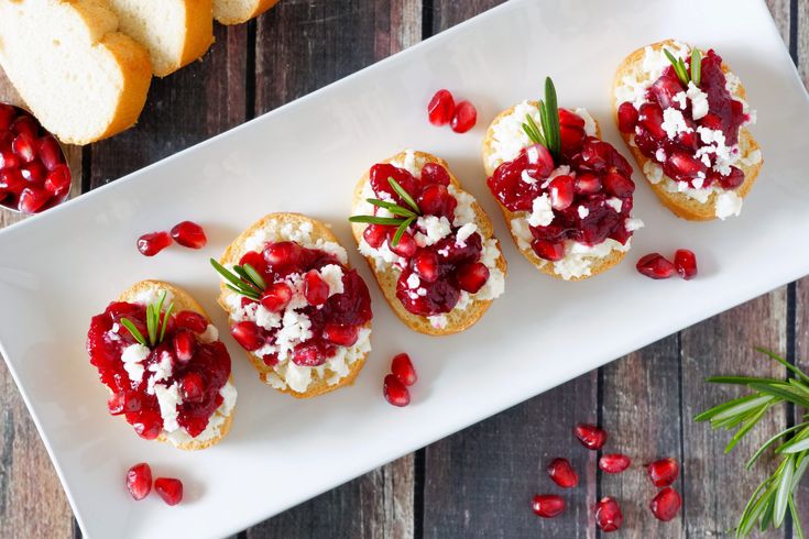 small appetizers with cranberry toppings on a white plate