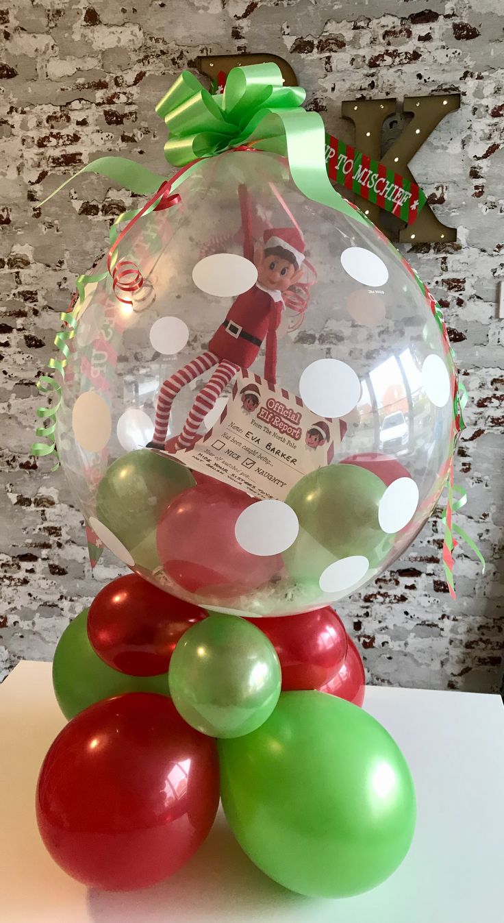 a christmas ornament on top of some balloons