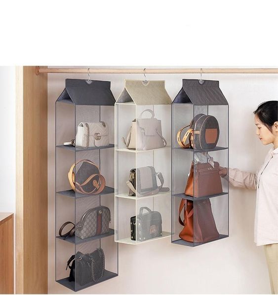 a woman standing in front of a wall mounted storage bag