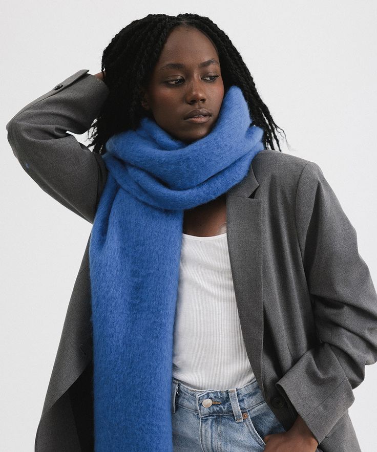 The Mik blanket scarf is the ultimate go to this winter. This super soft, oversized design can be styled various ways to fit your vibe. Let Mik hang long + low over your shoulders, wrapped tight around your neck or draped around your face for ultimate warmth from a chilly breeze! Knit Scarves For Cold Weather, Solid Color Scarves For Fall, One Size, Solid Color Scarves One Size For Fall, Solid One Size Scarves For Fall, Trendy Winter Scarves One Size, Fall Layering Shawl Scarf, Fall Shawl Scarf For Layering, Trendy One Size Winter Scarves, Blue Winter Scarves For Cold Weather