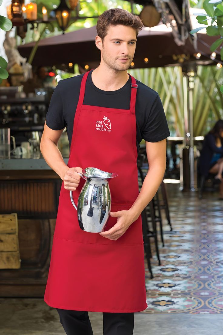 a man in an apron holding a silver vase