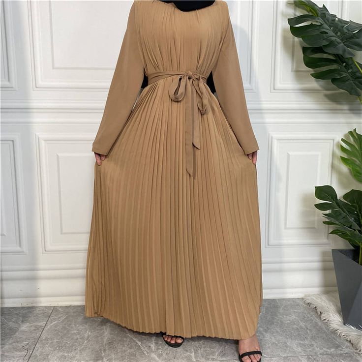 This beautiful nida pleated jumpsuit dress is the perfect outfit for any occasion. Includes with a belt, wide legged pants, long-sleeved arms, and a chiffon dress overlay. Available in 5 colours. Pleated Long Sleeve Chiffon Maxi Dress, Pleated Chiffon Maxi Dress With Long Sleeves, Long Sleeve Pleated Chiffon Maxi Dress, Beige Pleated Maxi Dress For Party, Beige Pleated Maxi Dress, Long Sleeve Maxi Dress With Pleated Waist For Summer, Brown Belted Dress For Spring, Summer Long Sleeve Maxi Dress With Pleated Waist, Spring Brown Dress With Belt