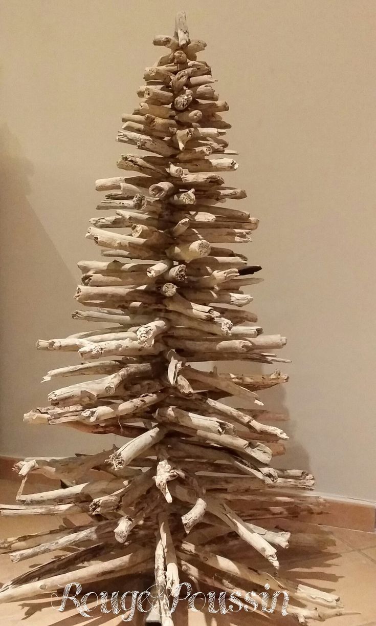 a wooden christmas tree made out of driftwood