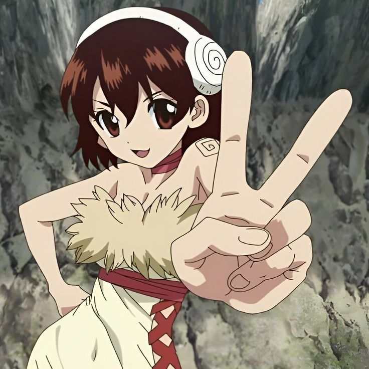 an anime character making the peace sign with her hand while standing in front of some rocks