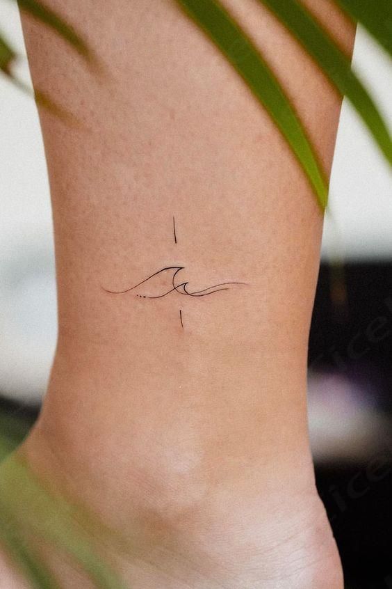 a woman's foot with a small wave tattoo on the left side of her ankle