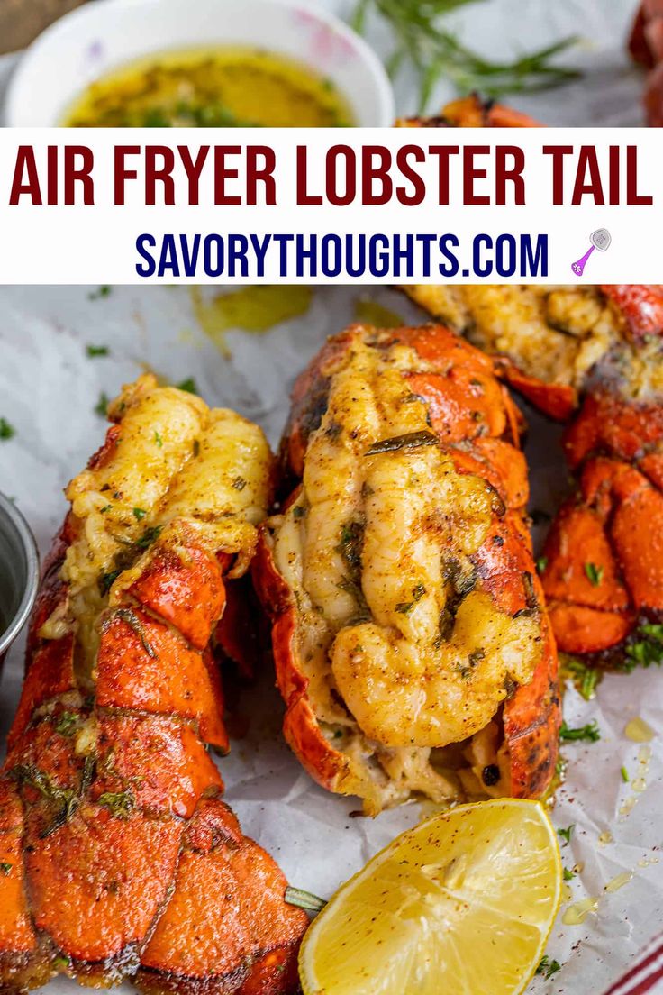 air fryer lobster tails with lemon wedges on the side and garnished with herbs