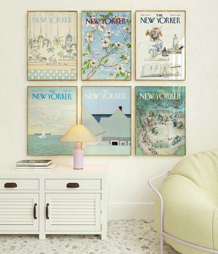 a living room with posters on the wall and a white chair in front of it