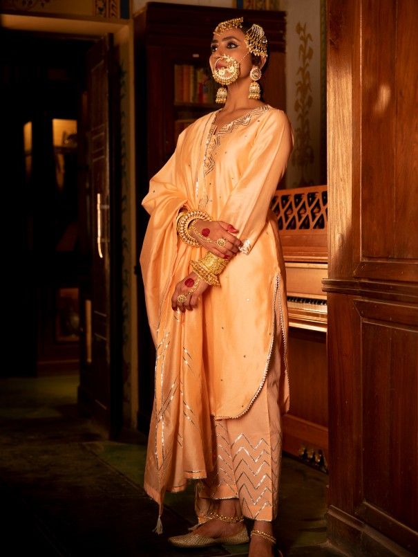 Enter the world of luxurious & regal clothing with Sahiba. Celebrate the grandeur of beauty, celebrations, dressing up and womanhood with vintage textiles and silhouettes. Set of 3 consists of kurta, pants and dupatta. Kurta: A pink chanderi silk kurta is detailed with silver gota embroidery . Dupatta: A pink chanderi silk dupatta is detailed with hand embroidered gota dhari work and tassels. Bottom: Combined with pink cotton pants with gota embroidery Material: Chanderi Silk Color: Pink Note: A Gota Embroidery, Kurta Pants, Embroidery Dupatta, Punjabi Suits Designer Boutique, Kurta Pant Set, Silk Kurta, Embroidered Pants, Silk Outfit, Suits Design