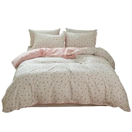 a bed with pink and white comforter on it's side, in front of a white background