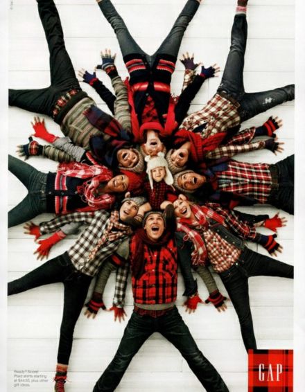 a group of people standing in the middle of a circle with their arms up and legs spread out