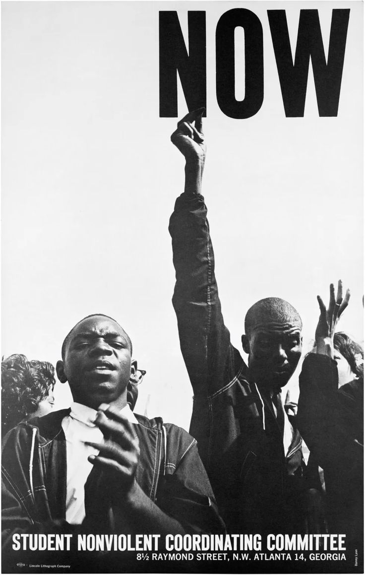 a black and white photo of two men holding up a sign that says, now student nonvalentnt coordinating committee