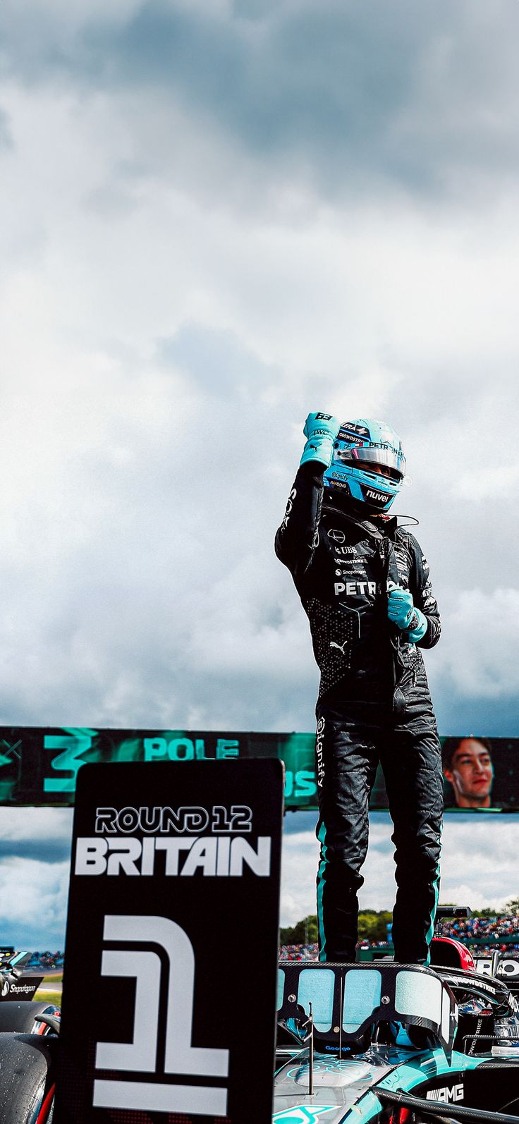 a man standing on top of a race car