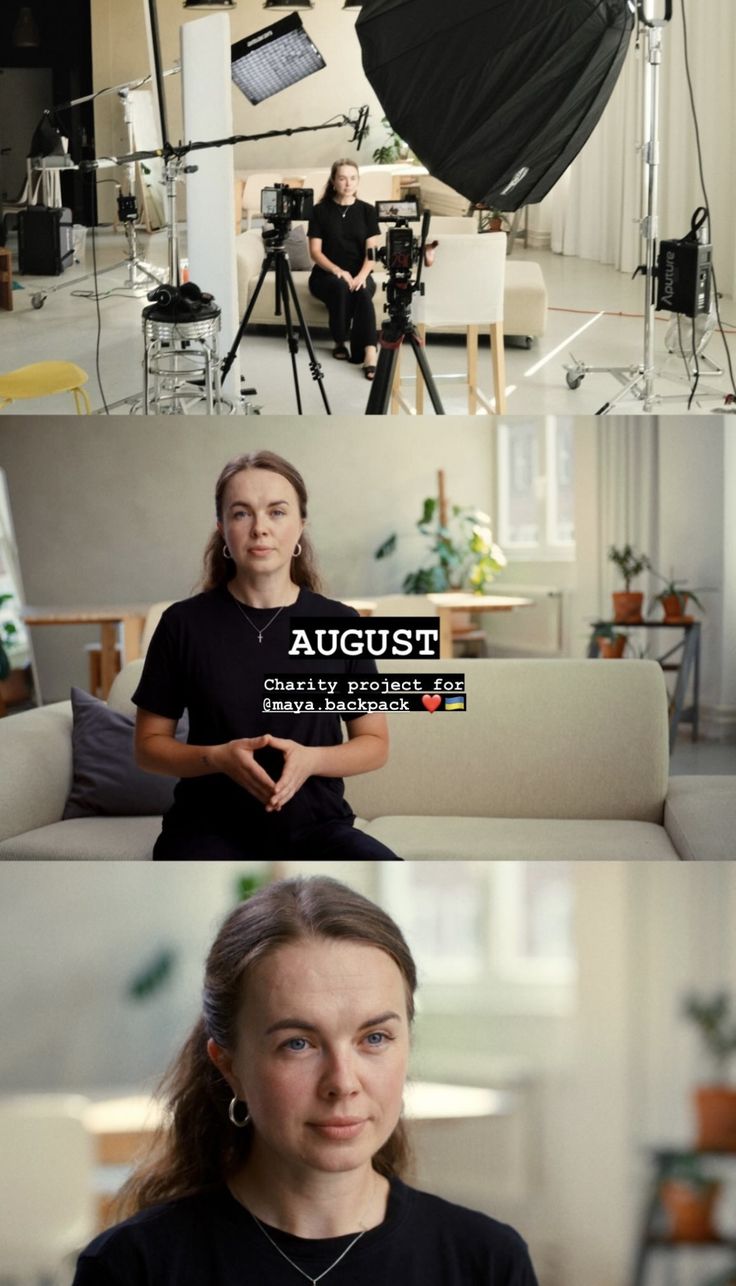 two women are sitting on a couch and one is standing in front of the camera