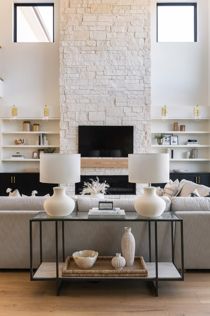 a living room filled with furniture and a fire place next to a wall mounted tv