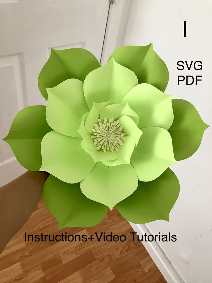 a large paper flower sitting on top of a wooden floor