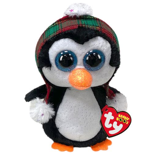 a stuffed penguin wearing a hat and scarf with a tag on it's chest