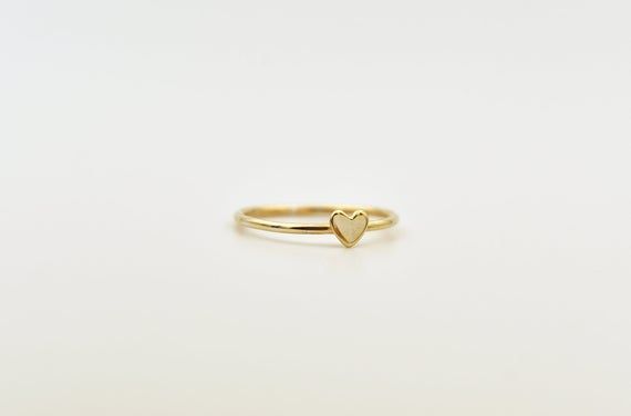 REAL 14k gold !❤️ "LOVE is  in the air!"  Delicate 14k GOLD tiny heat ring full of love, so you can keep it close to your hear!This dainty ring is perfect to wear it alone or stacking it with other rings to get a total look. ❀➤Features:♦ Metal: 14k SOLID GOLD (Rose or Yellow)♦ Bandwidth: 1 mm/ 18 gauge♦ Heart Size : 4 mm ➤ PACKAGINGItem will arrive in pretty gift packaging. If you are purchasing it as a gift please feel free to add a personal note.➤ 100% HAND MADE - Each item is handcrafted indi Dainty 14k White Gold Heart Ring, Tiny 14k Gold Heart Ring For Gift, 14k Gold Tiny Heart Ring For Gift, White 14k Gold Heart Cut Heart Ring, Tiny Gold Heart Ring For Wedding, Dainty 14k Gold Heart Ring, White 14k Gold Heart Ring As Gift, White 14k Gold Heart Ring, 14k Gold Heart-shaped White Rings