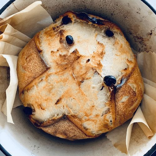 a baked item in a bowl with some napkins around it