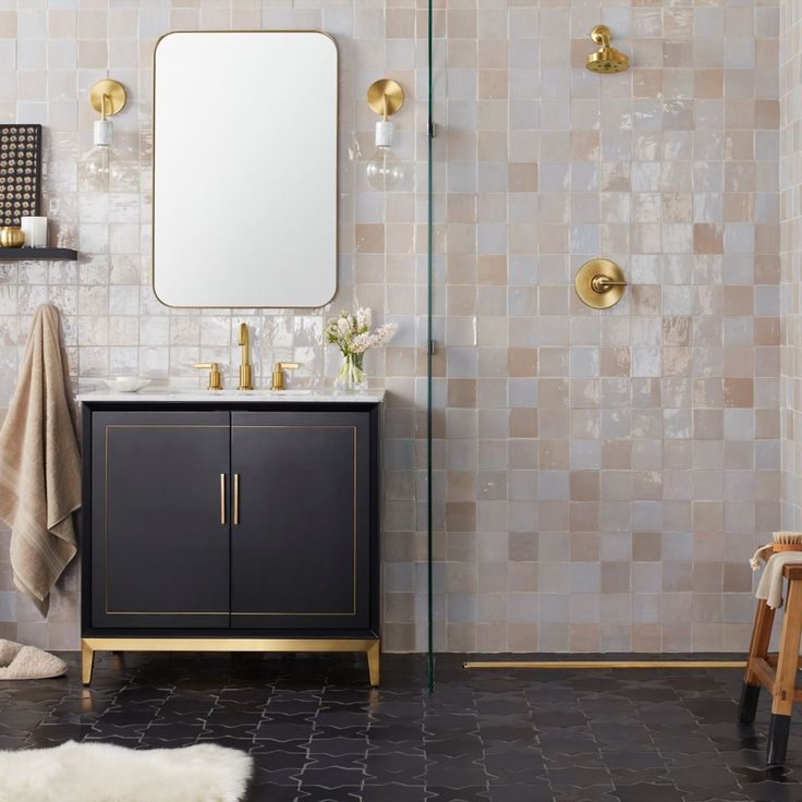 a bathroom with a sink, mirror and towel rack on the wall next to it