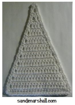 a crocheted triangle is shown in white