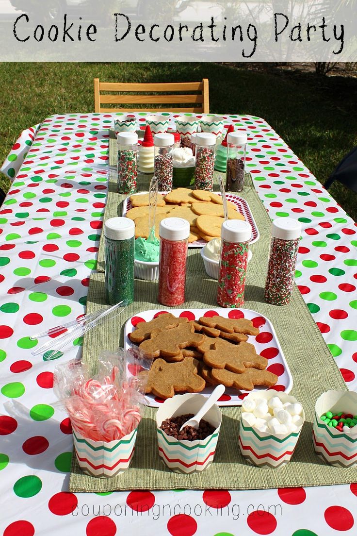 a table topped with cookies and cupcakes on top of a polka dot covered table cloth