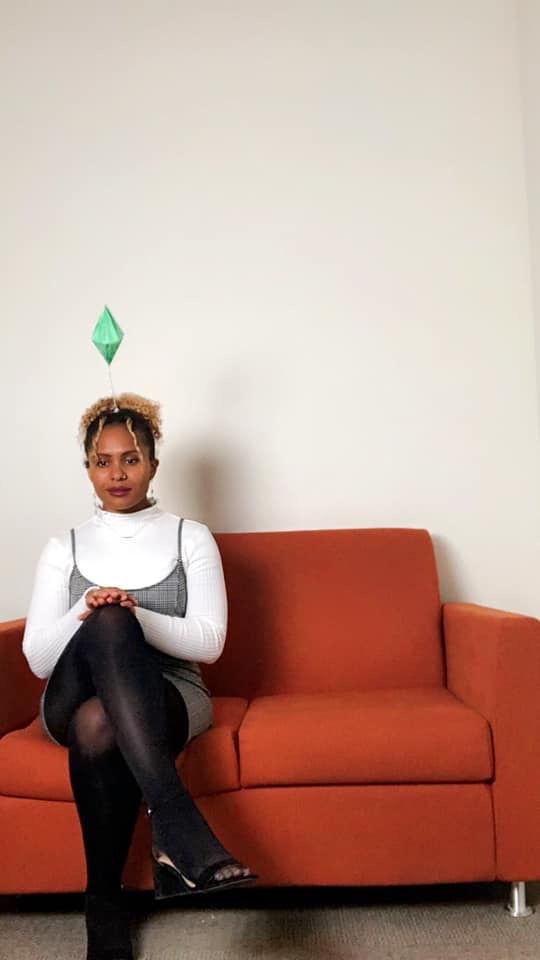 a woman sitting on top of a red couch