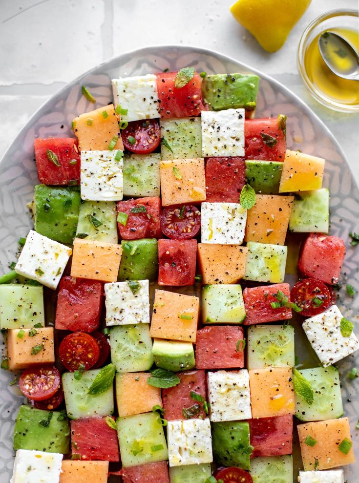 a plate filled with lots of different types of food on top of a white table