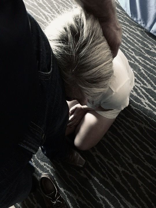 a person bending over on the floor with their head down