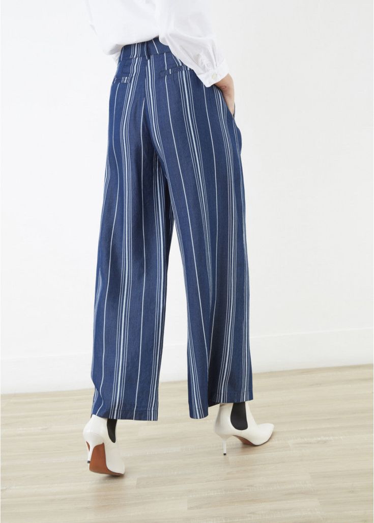 Wide flowing tencel pants with large stripes and Italian pockets on both sides. Closes with a front button. Cool, breathable, and flowing. Vertical stripes are always flattering, and this chic wide-leg style in lightweight woven Tencel is no exception. Sits slightly higher on the hips, with beautifully tailored double-pleat front. Details: zip-and-button fly, side welt pockets, back besom pockets, and belt loops all around. 100% Tencel™ Fun fact: Tencel is of botanic origin and defines a new sta Flowing Pants, Tencel Pants, Vertical Stripes, Fun Fact, Striped Pants, Wide Leg Pants, Wide Leg, Stripes, Wardrobe