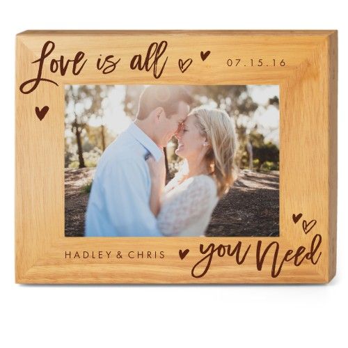 a wooden frame with the words love is all you need