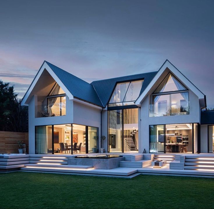 a modern house that is lit up at night