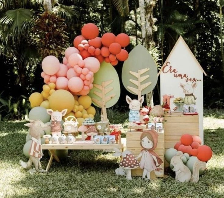 an outdoor party with balloons and decorations