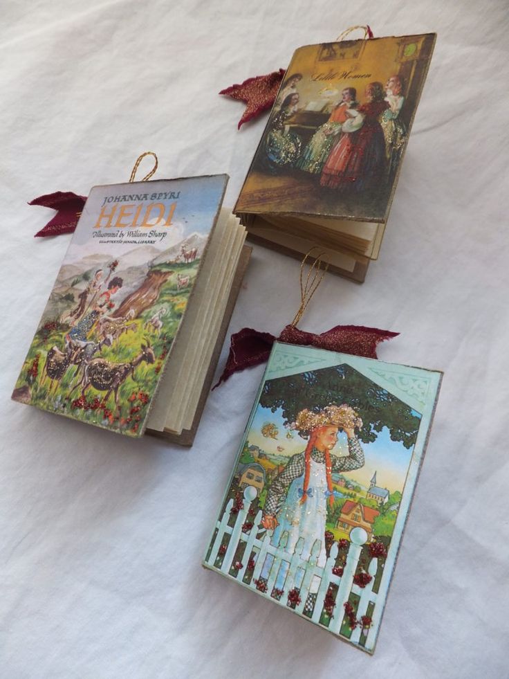 three children's books sitting on top of a white sheet