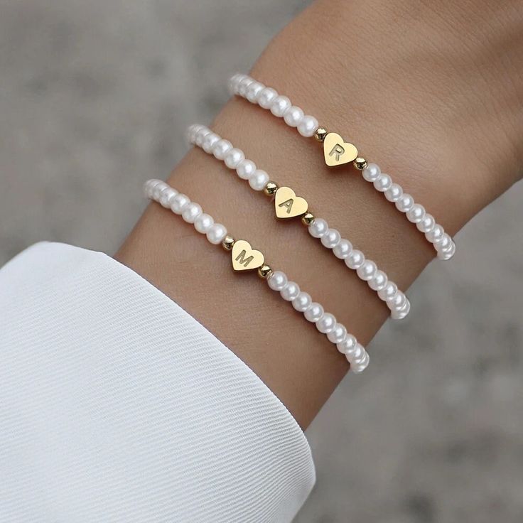 Indulge in timeless elegance with our Hot Classic A-Z Heart Initial Letter Bracelet, a women's temperament jewelry piece adorned with imitation pearl beads. This chic bracelet, featuring 4mm bead width and a heart size of 6x7mm, exudes classic beauty and trendy style. With a length of 18cm, it's a perfect accessory to complement any ensemble. Elevate your fashion with this elegant and chic initial bracelet, making it an ideal women's gift for any occasion. The A-Z letters add a personalized touch, and the imitation pearls create an effortlessly stylish and charming look. The 18cm length ensures versatility for various wrist sizes, making it a chic accessory for any fashion-conscious individual. Explore our store for more exquisite jewelry styles to enhance your collection. From heart brace Engraved Initials, Birthday Gifts For Teens, Letter Bracelet, Stil Elegant, Personalized Pendant, Elegant Bracelet, Initial Bracelet, Hand Chain, Birthday Jewelry Gift