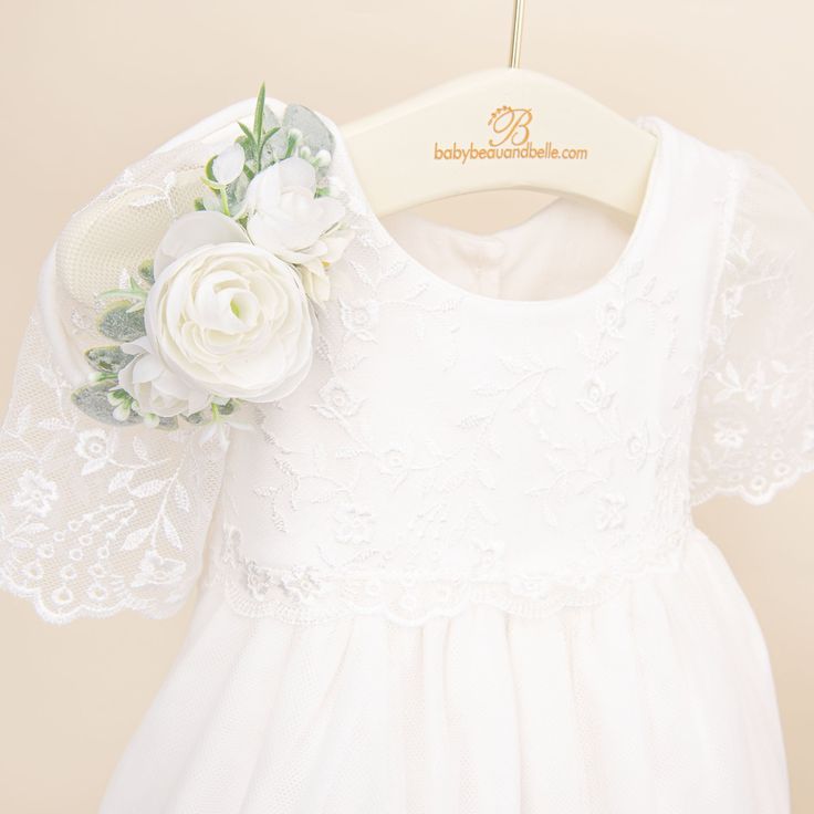 Handmade in the USA An elegant gown that is sure to make your little one the star of their special day! The Ella Christening Gown is made with a detailed flower and vine embroidered netting lace in light ivory with a mini scalloped edge for a classic and vintage heirloom style. A sweet flutter sleeve is the perfect accent to the styling of this gown! A two-tiered lace skirt creates added fullness and flounce, and is lined in a super soft and light weight cotton, while the romper is made in a sof Baptism Dress With Lace Bodice And Organza Material, Lace First Communion Dress With Fitted Bodice, Fitted Floral Applique Dress For Ceremony, Fitted Tulle Gown For Confirmation, Wedding Gown With Floral Applique And Fitted Bodice, Elegant Tulle Lace Dress With Floral Applique, Fitted First Communion Dress With Lace Sleeves And Tulle, Fitted Tulle First Communion Dress With Floral Applique, Elegant Lace First Communion Dress With Floral Applique