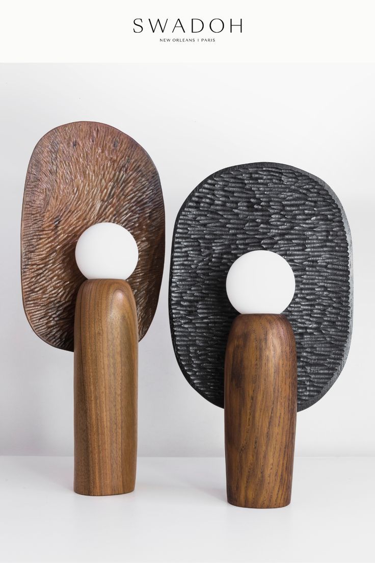 two wooden sculptures sitting next to each other