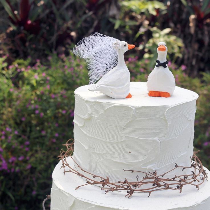 a wedding cake with two birds on top