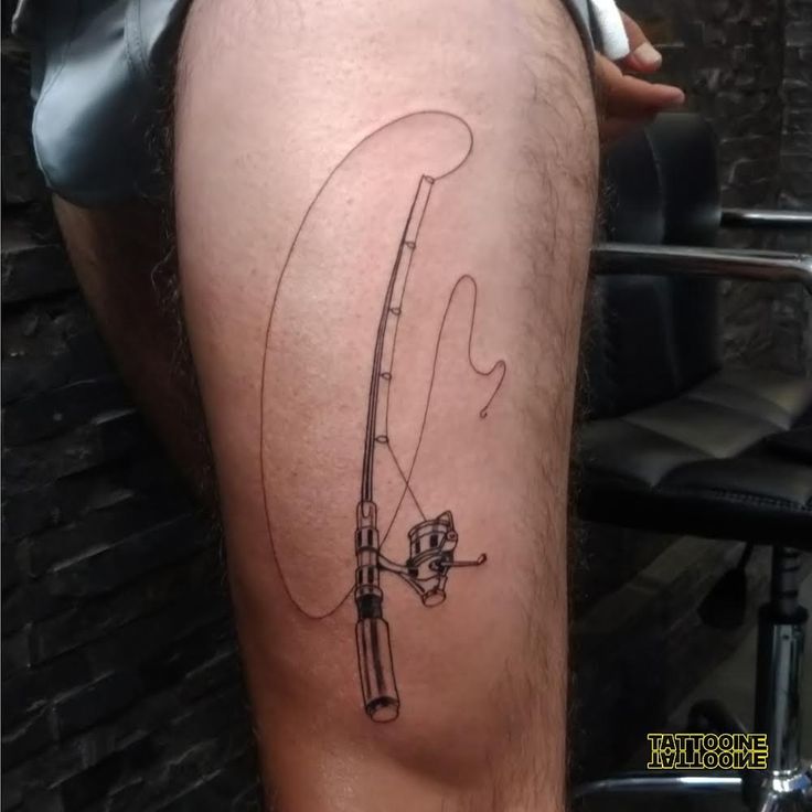 a man with a fishing pole tattoo on his thigh and leg, holding a fishing rod