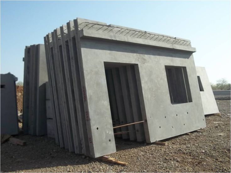 a building made out of concrete sitting on top of gravel