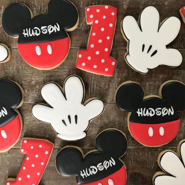 mickey mouse cookies are arranged on a wooden table with the word hudson painted on them