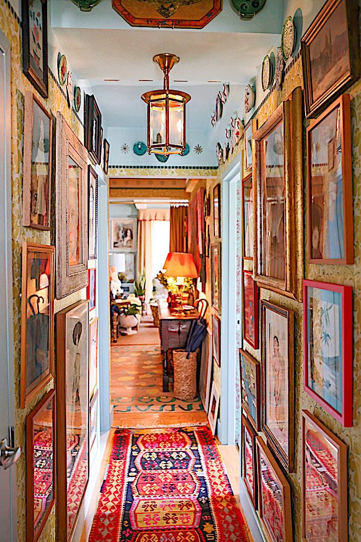 the hallway is decorated with paintings and lamps