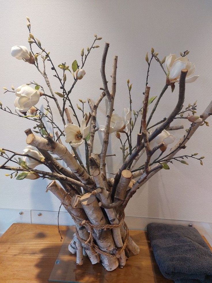 a vase filled with white flowers on top of a wooden table