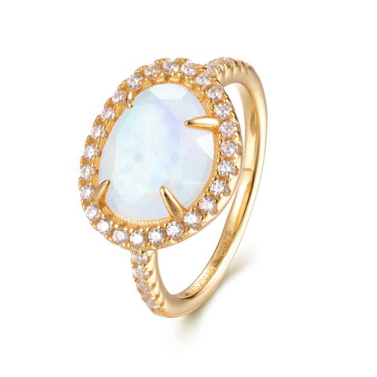 Introducing the Skye Moonstone Ring—a classic piece that features a genuine Rainbow Moonstone, beautifully framed by a halo of sparkling crystals on a pave band. Choose between luxurious 14k Gold Vermeil or elegant Sterling Silver, and let this naturally stunning gemstone captivate you with its unique charm. Each Rainbow Moonstone is handpicked for its individual beauty, ensuring that your ring is truly one-of-a-kind. Details:Gemstone: 9x11mm Genuine Rainbow MoonstoneRing Face (including crystal halo): 14mm x 11.8mmBand Width: 1.8mm Elevate your jewelry collection with the Skye Moonstone Ring—a perfect blend of elegance and enchantment. Elegant Gold Moon-shaped Moonstone Ring, Gold Moon Shaped Elegant Ring, Elegant Yellow Gold Moonstone Ring With Round Stone, Elegant Gold Moon-shaped Ring, Elegant Gold Moon Shaped Ring, Elegant Moon Shaped Gold Rings, Elegant Moon Shaped Diamond Rings, Fine Jewelry Moonstone Ring With Halo Setting, Fine Jewelry Moonstone Ring With Halo For Formal Occasions