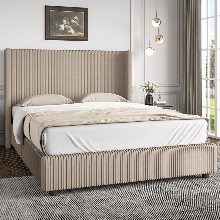 a bed with a beige headboard sitting in a bedroom next to a large window