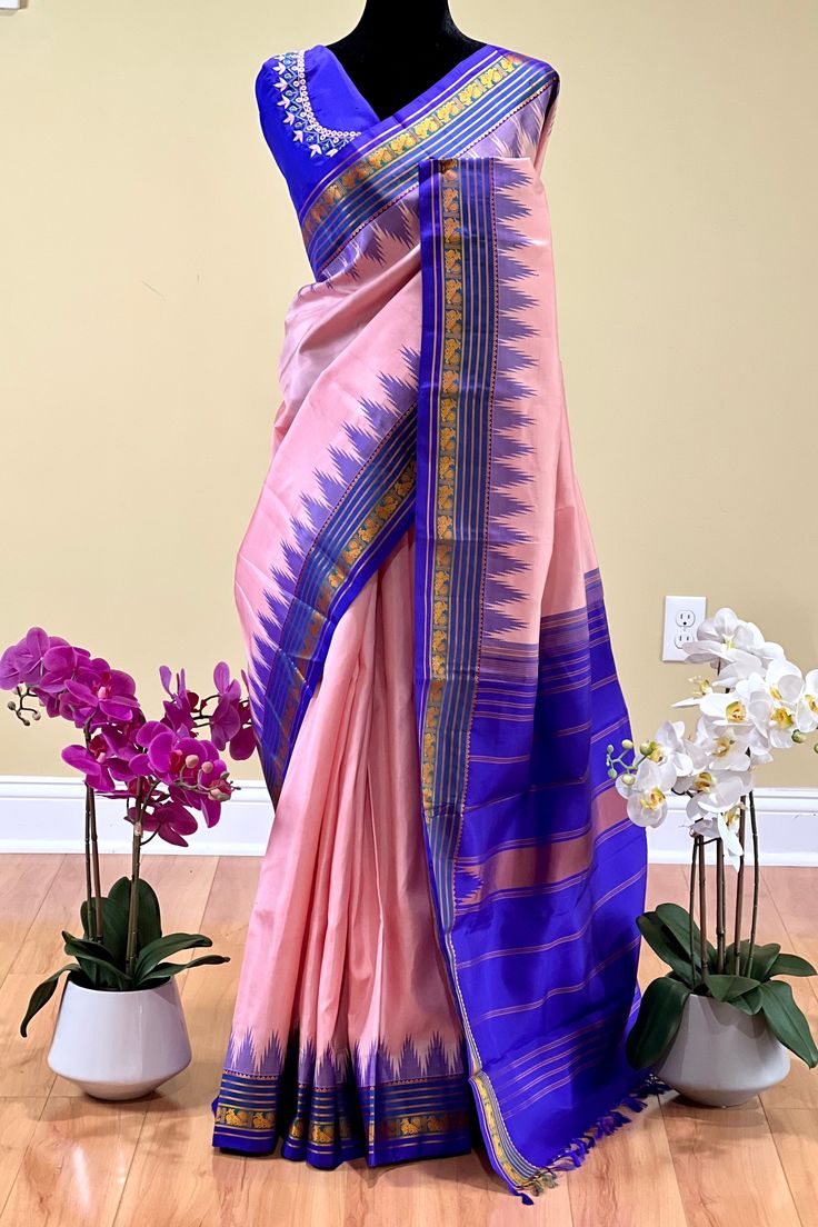 Fabric : Pure Kanjivaram Silk Type : Thread work korvai contrast Body Color : Light lotus pink Border Color : Bluish purple Blouse Color: Bluish purple Pallu Color: Bluish purple Approximate height - 46 - 52" Approximate weight - 1.4 lbs Approximate Length - 6.25 - 6.50 mtrs (inclusive of blouse length) Technique on the blouse : Aari and mirror work Saree comes with fall, picot and tassels done when applicable. Blouse piece is cut. Kindly Note : The colors you see on your device may vary due to Purple Saree With Border In Traditional Drape, Purple Art Silk Traditional Wear With Border, Pink Art Silk Traditional Wear With Border, Pink Traditional Wear With Border For Puja, Pink Traditional Wear For Diwali With Border, Pink Saree With Border For Puja, Pink Saree With Border For Festivals, Pink Saree With Border, Festive Pink Saree With Border Details